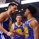 Klay Thompson, left, and Quinn Cook, right, of the Golden State Warriors celebrate the play against the Toronto Raptors.